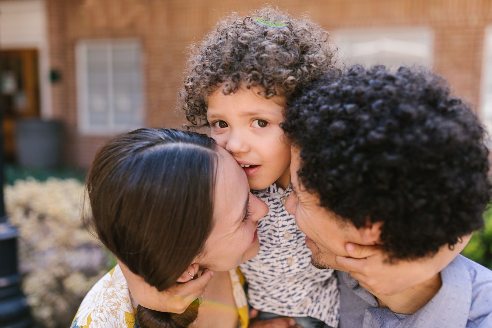 Parents and child sharing a warm outdoor hug — life insurance for the people you love